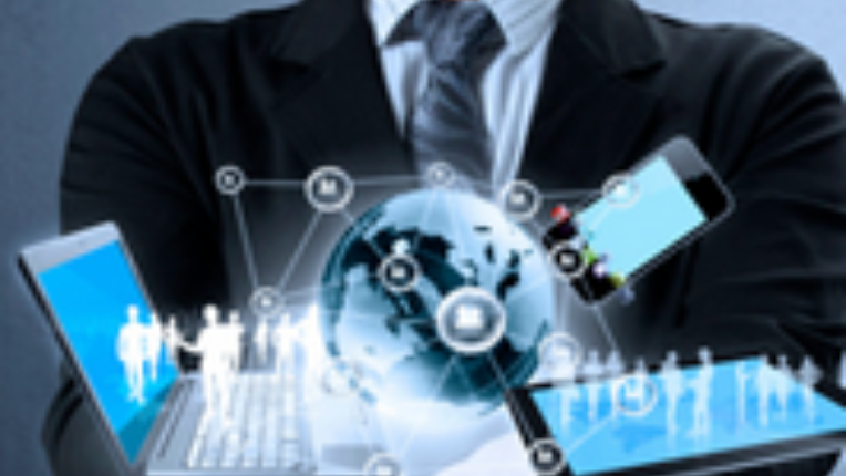 Hands with globe surrounded by laptop cell phone and tablet