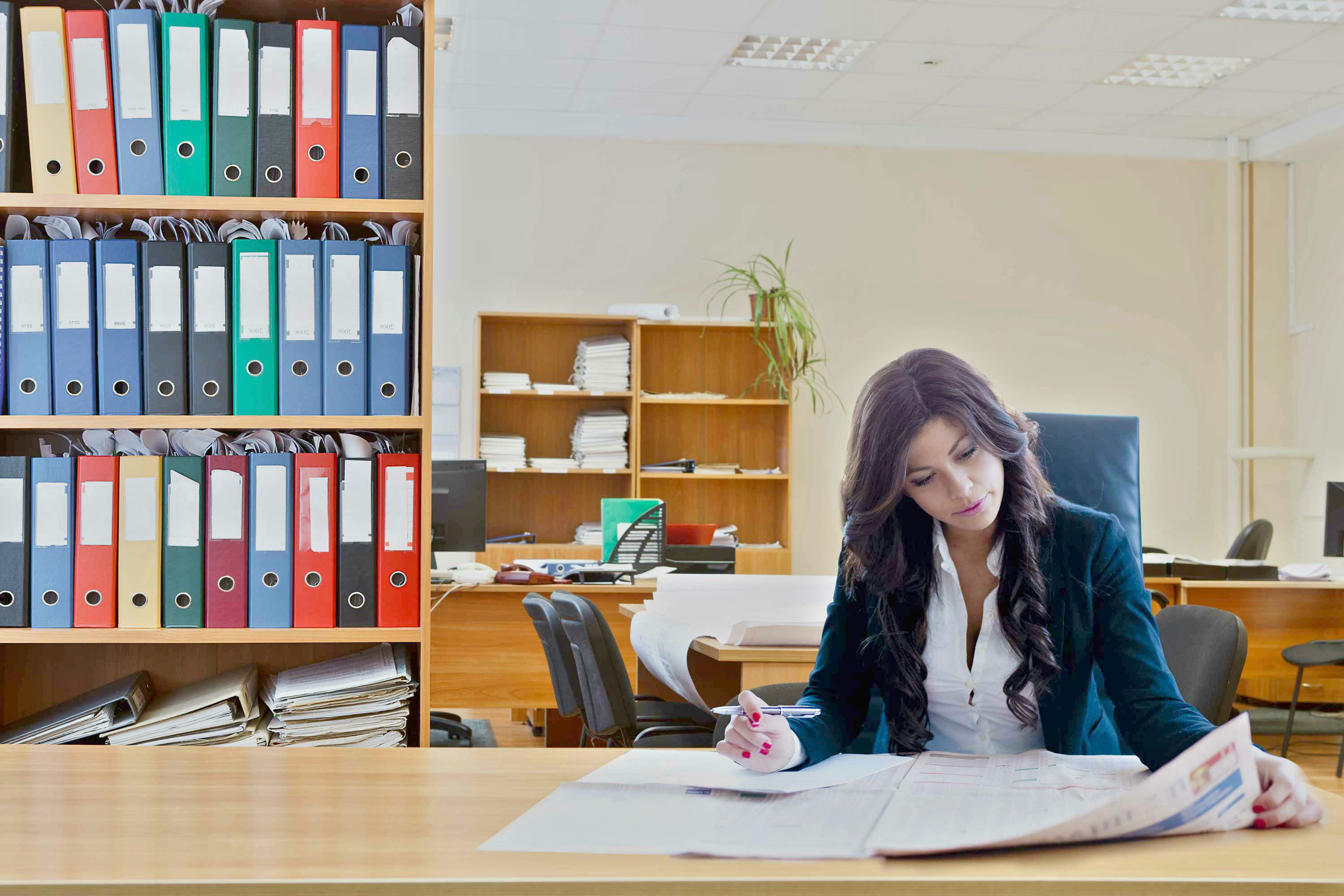 a woman sitting in a library reading a book